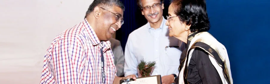 Alumni presenting an award at a TNMC event